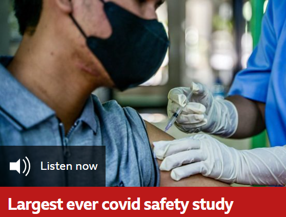 Photo of a person wearing a mask receiving a vaccine